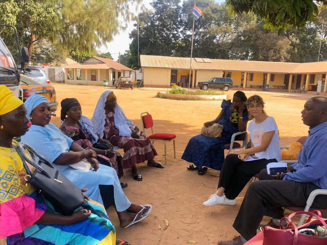 IWORDS team member meeting with community members in the field